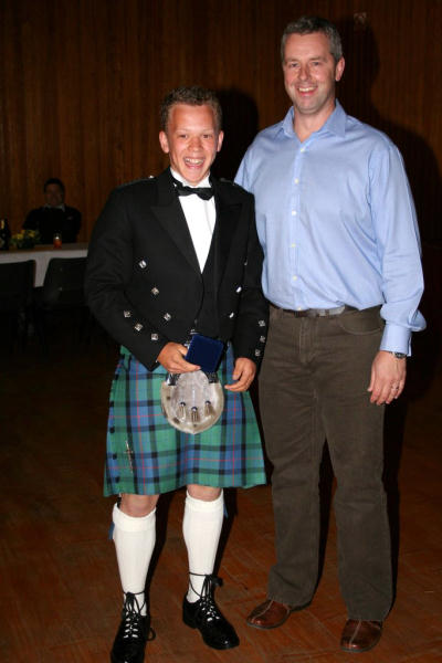 Annan RFC's under 17 Scotland Player Mark Clark receiving a medal marking the honour from coach Paul Buckley 